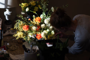 Diddle and Zen founder Abby Matson arranging flowers.