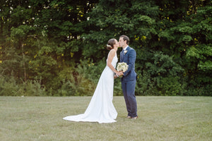 A bride and groom with wedding flowers by Diddle and Zen